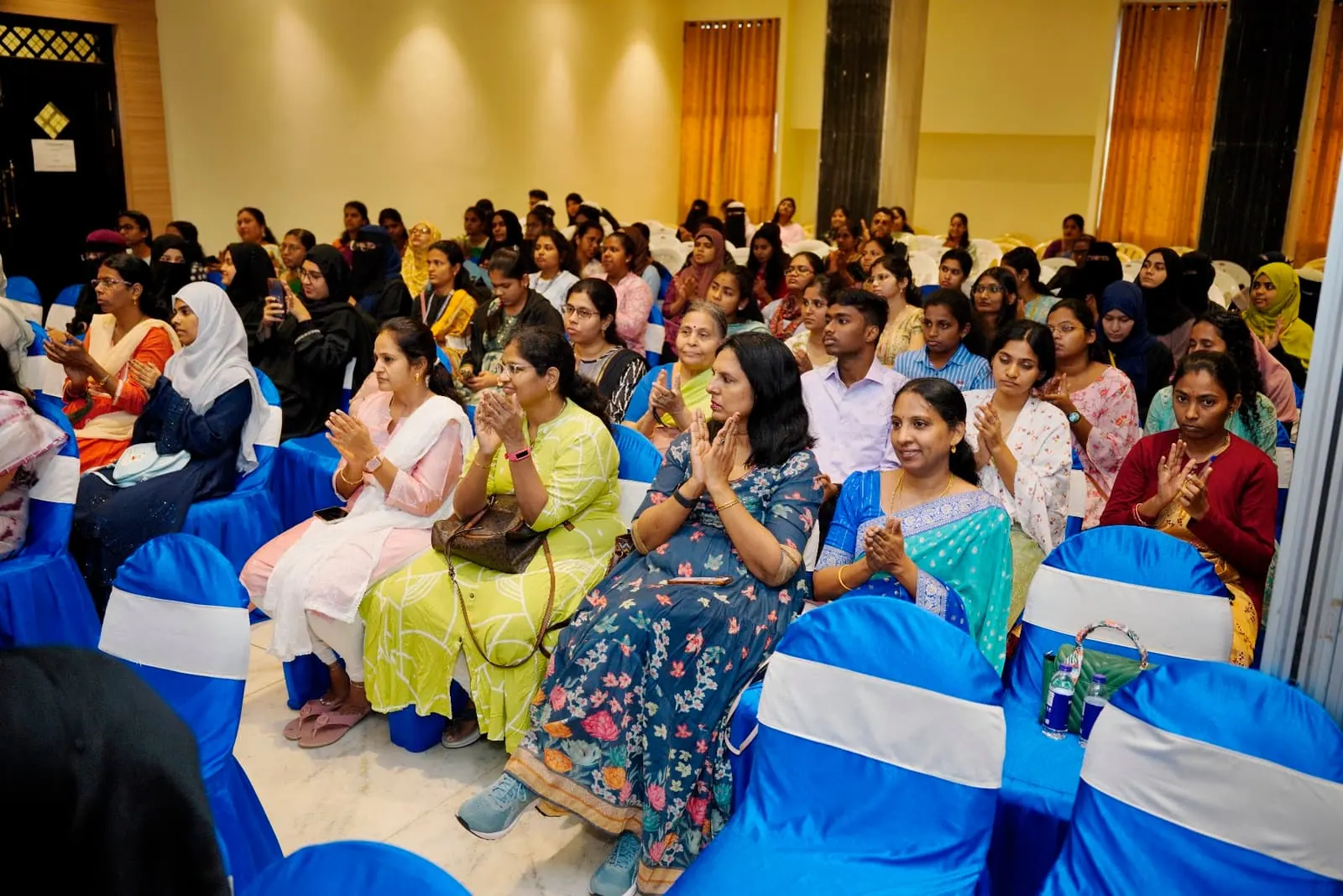 Participants applauding during a HolistiCon 2024 session
