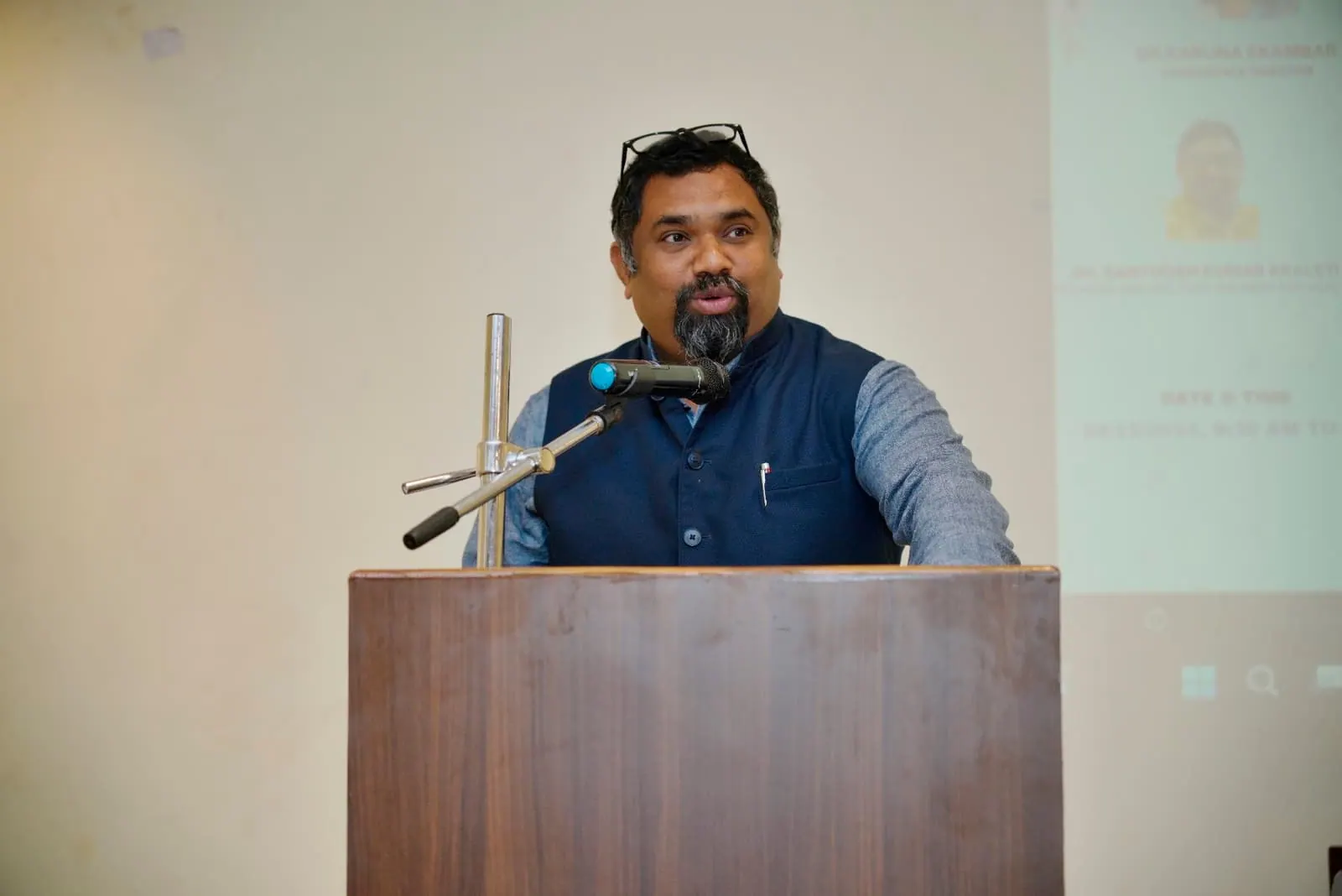 A speaker addressing HolistiCon 2024 from the podium