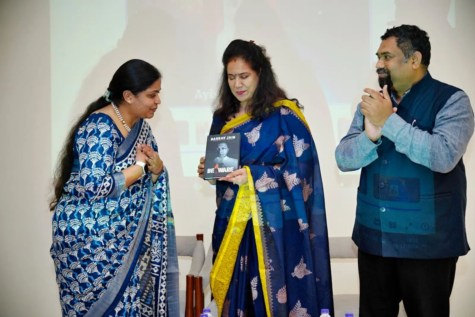 A book being presented on stage at HolistiCon 2024