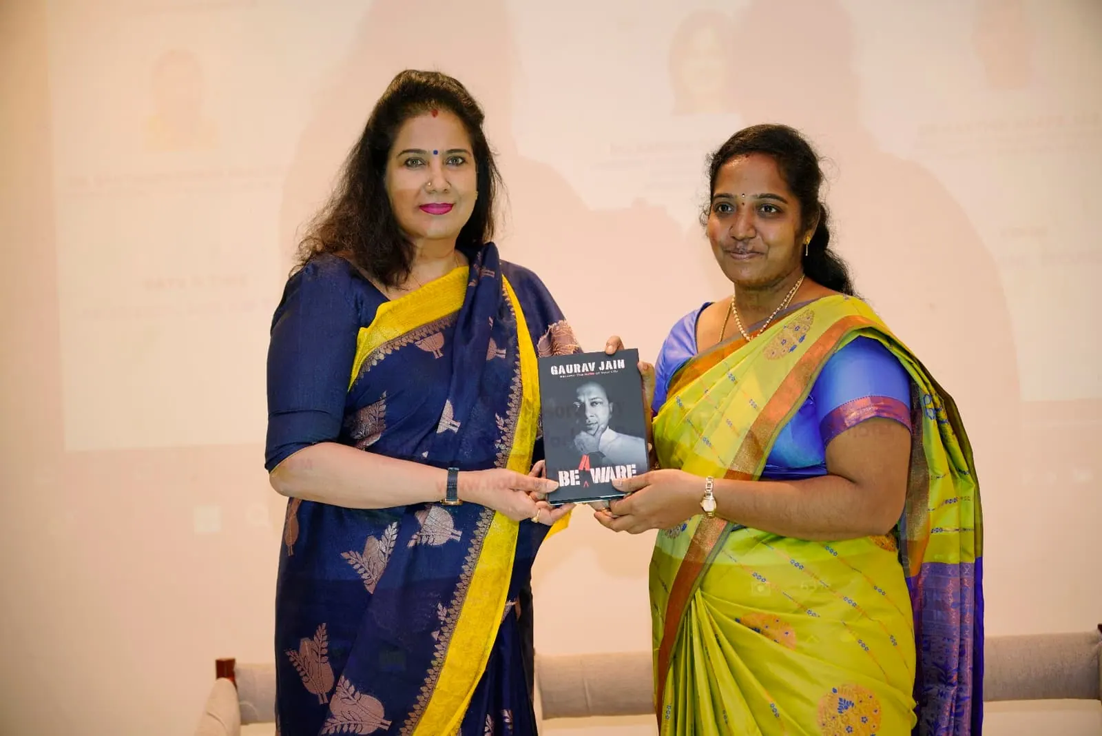 Two participants with a book presented at HolistiCon 2024